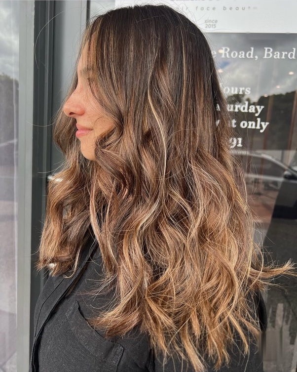 Long caramel balayage with soft beachy waves