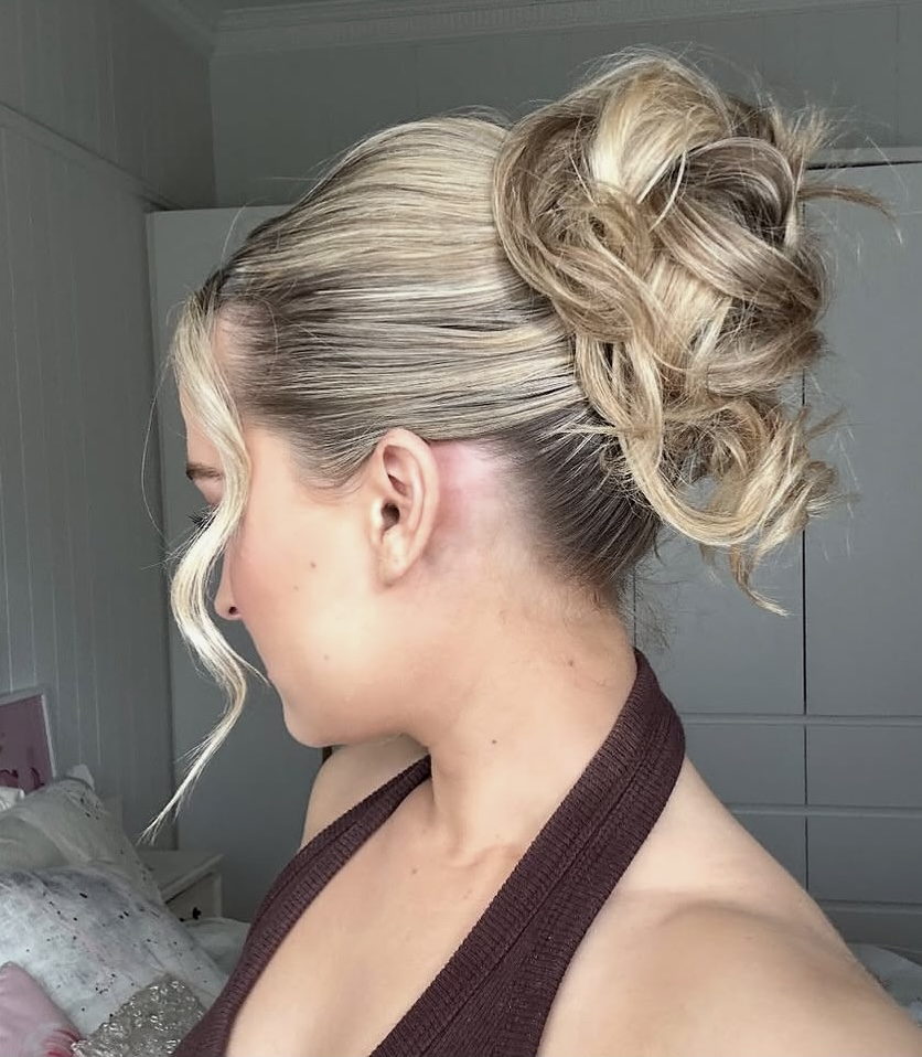 Textured blonde high bun with soft curls